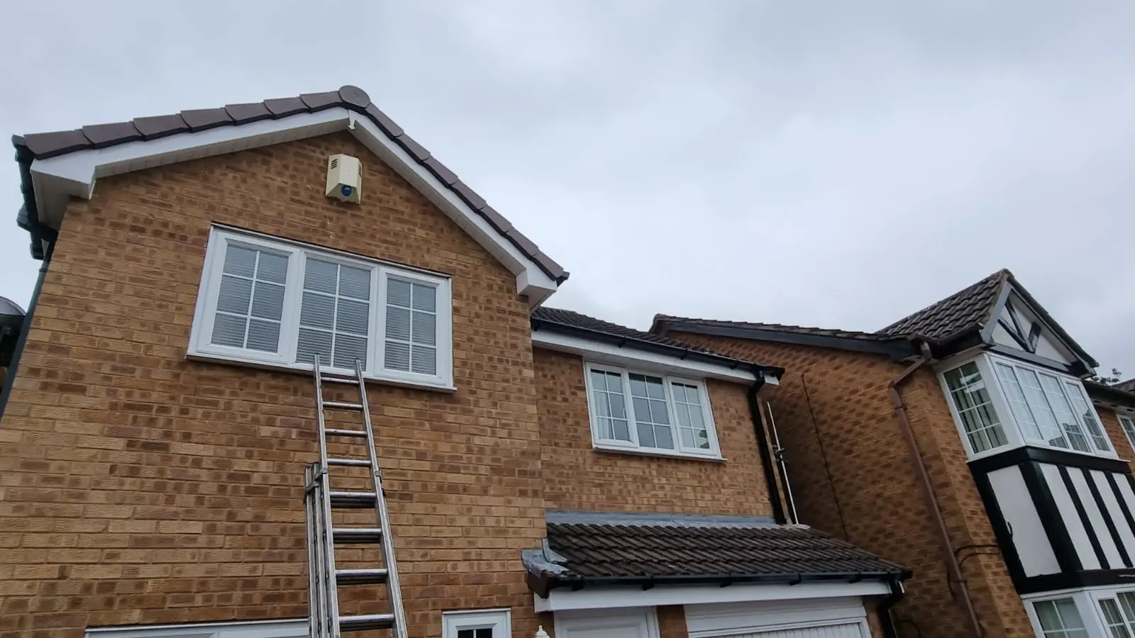 Ladder against a Midlands house during a roof inspection by Westridge Roofing Birmingham