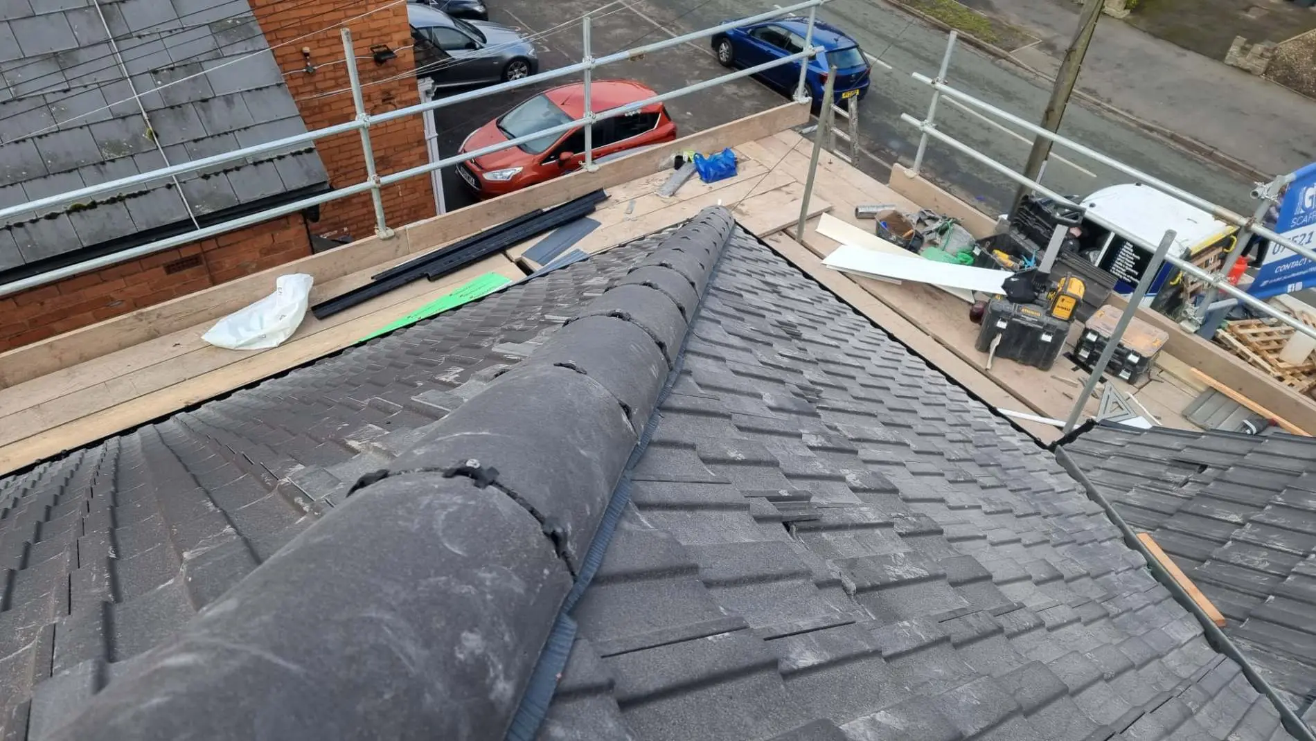 Roofers stripping and re-tiling a pitched roof with scaffolding Westridge Roofing Birmingham